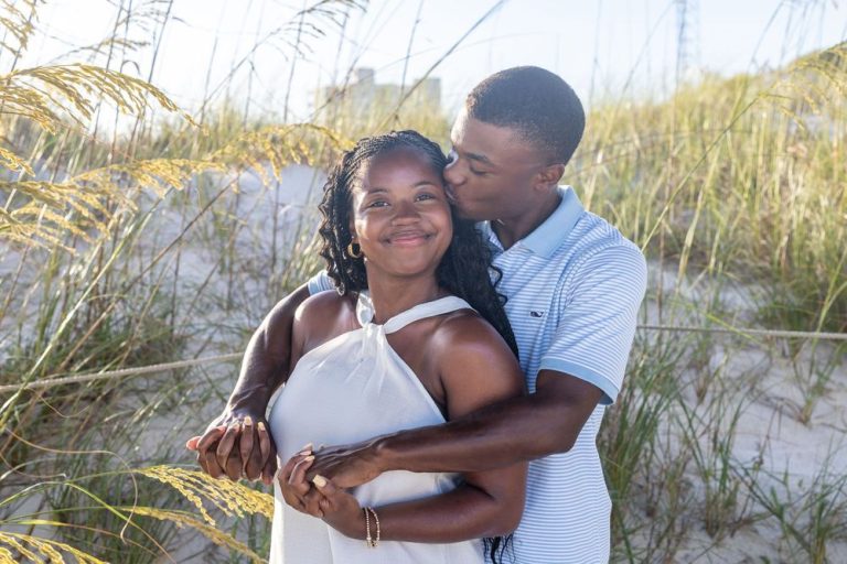 Intimate couple portraits among beach grass and dunes at sunset